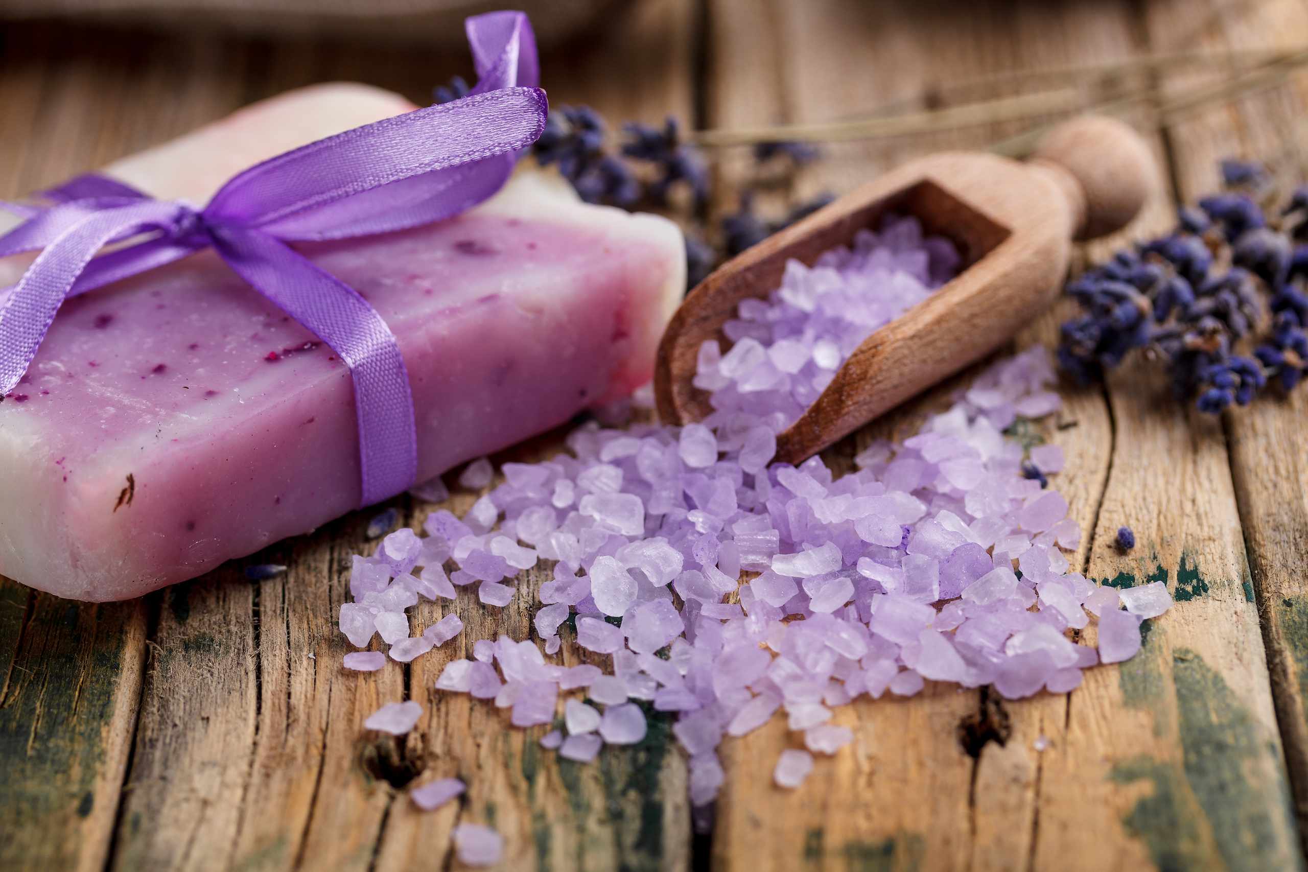 Lavender soap and bath salts on a wooden surface